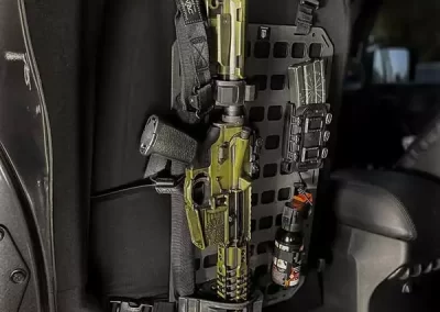 gun ar-15 attached to the vehicles back seat mounted with a gun holder