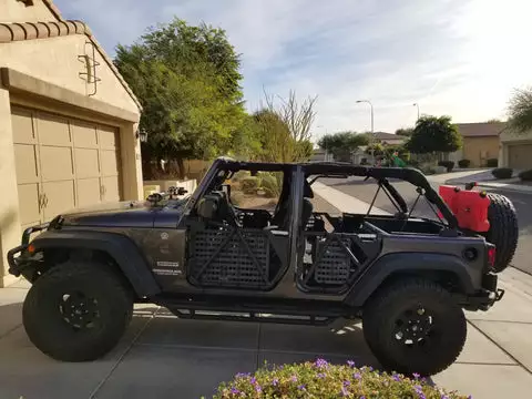 Jeep with the doors off and molle panel on the cross bars